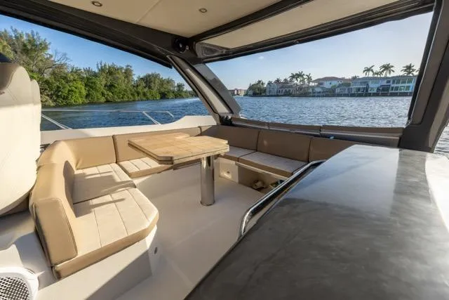 Slide: The Image of Luxurious 2019 Absolute 40 SLT yacht interior with elegant seating and scenic waterfront view. - 38