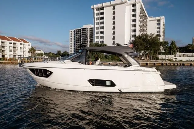 Slide: The Image of 2019 Absolute 40 SLT yacht cruising near waterfront buildings. - 41