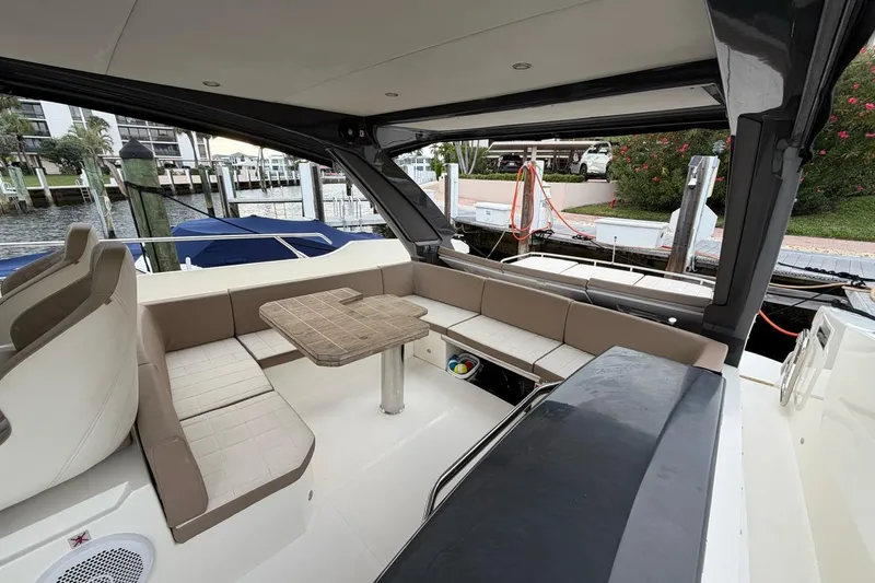 Slide: The Image of 2019 Absolute 40 SLT yacht cockpit with steering wheel, dashboard, and river view. - 21