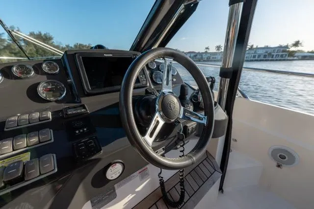 Slide: The Image of Cockpit of 2019 Absolute 40 SLT yacht with modern controls and scenic water view. - 34