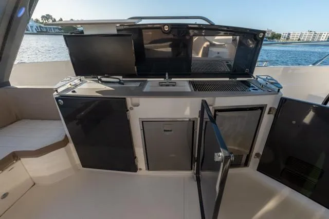 Slide: The Image of 2019 Absolute 40 SLT yacht kitchen with open cabinets and modern appliances. - 44