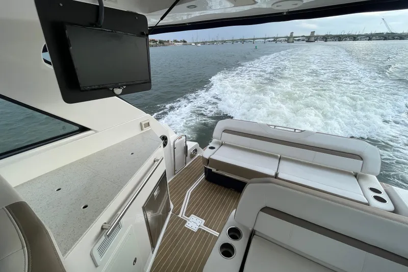 Slide: The Image of 2017 Regal 35 Sport Coupe interior with seating, TV, and ocean view. - 23