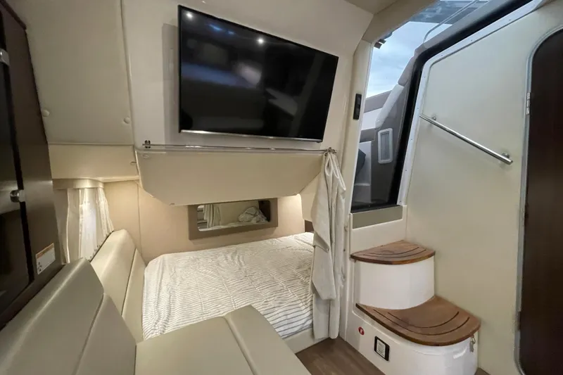 Slide: The Image of Interior of 2017 Regal 35 Sport Coupe with bed, TV, and stairs. - 27