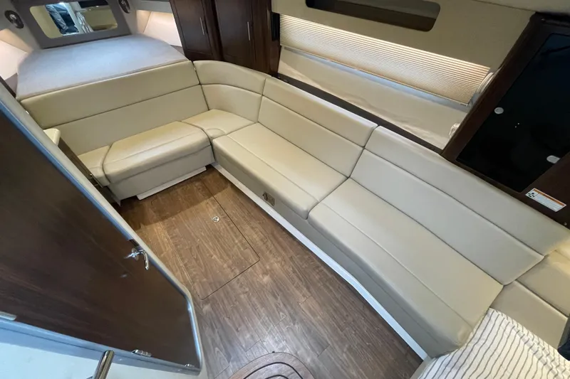 Slide: The Image of Interior of 2017 Regal 35 Sport Coupe with beige seating and wood flooring. - 31