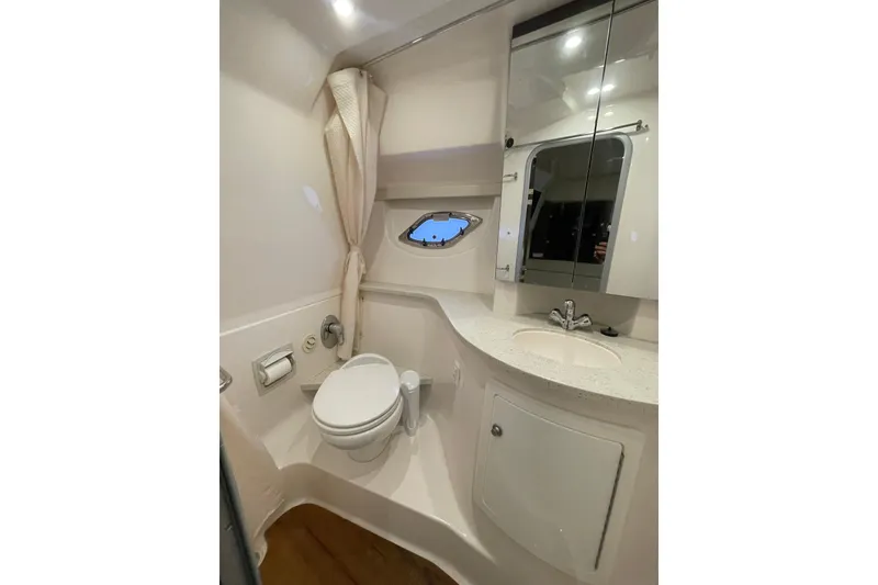 Slide: The Image of Luxurious bathroom in 2017 Regal 35 Sport Coupe yacht with modern fixtures and porthole window. - 33