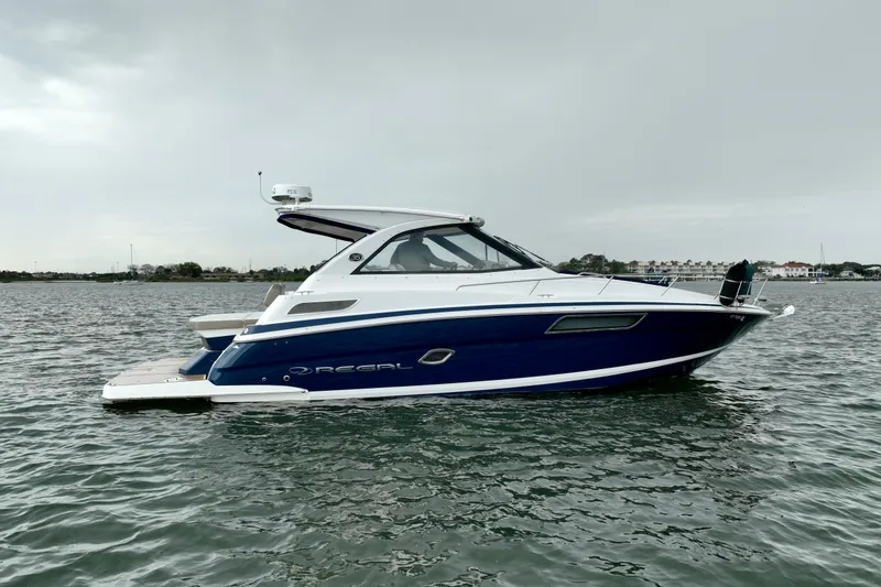 Slide: The Image of 2017 Regal 35 Sport Coupe boat on calm water, side view. - 4