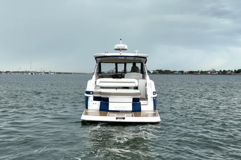 Slide: The Image of 2017 Regal 35 Sport Coupe on calm water, rear view with overcast sky. - 6