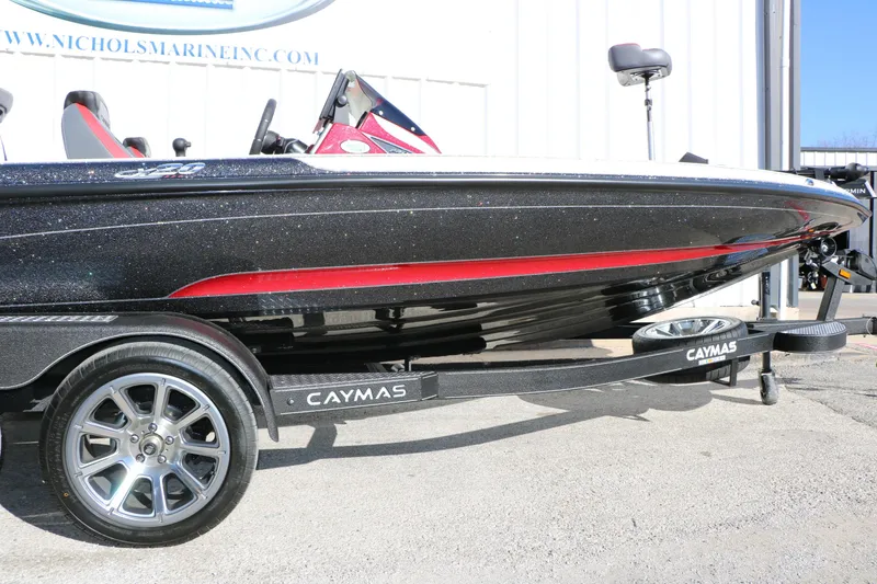 Slide: The Image of 2025 Caymas CX 20 PRO boat on trailer, black and red design, side view. - 13