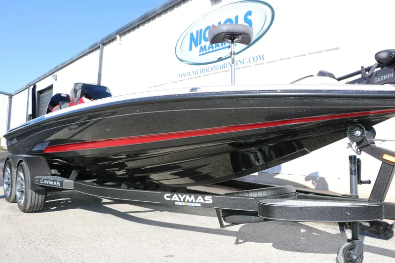 Slide: The Image of 2025 Caymas CX 20 PRO boat on trailer, black with red accents, at Nichols Marine. - 14