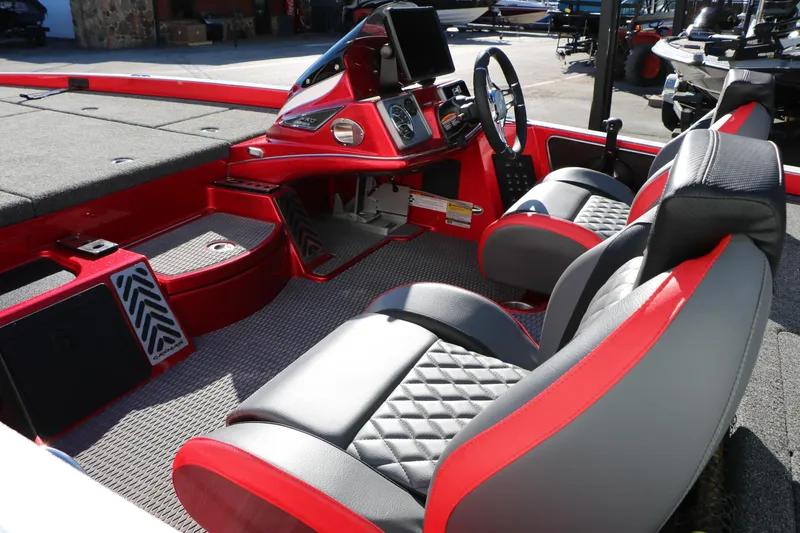 Slide: The Image of 2025 Caymas CX 20 PRO boat interior with red and black seating and modern dashboard. - 16