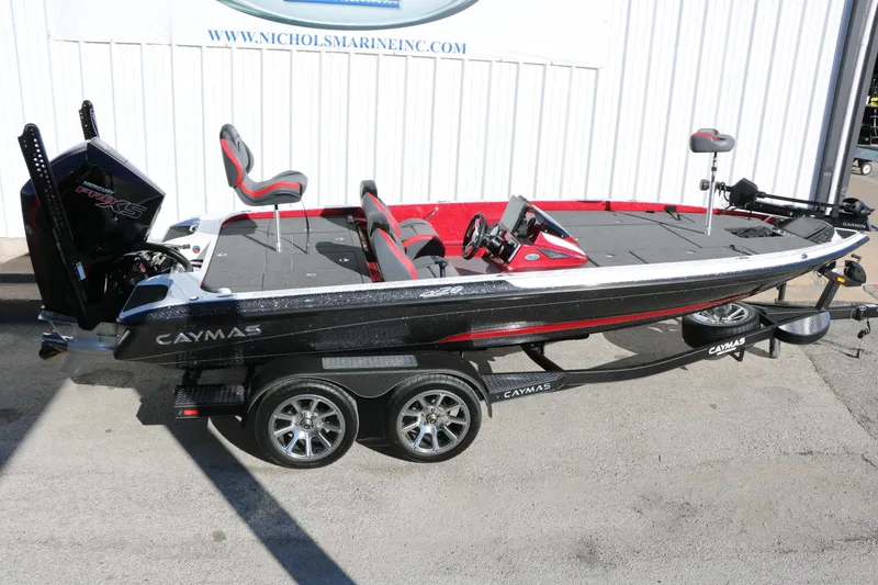 Slide: The Image of 2025 Caymas CX 20 PRO bass boat on trailer, black and red design. - 18