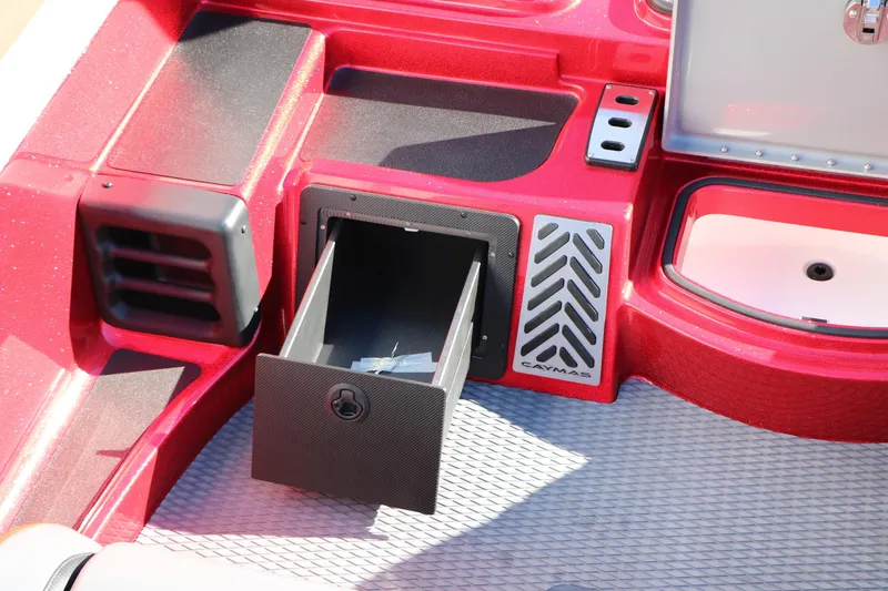 Slide: The Image of 2025 Caymas CX 20 PRO boat interior with open storage compartment and red finish. - 32