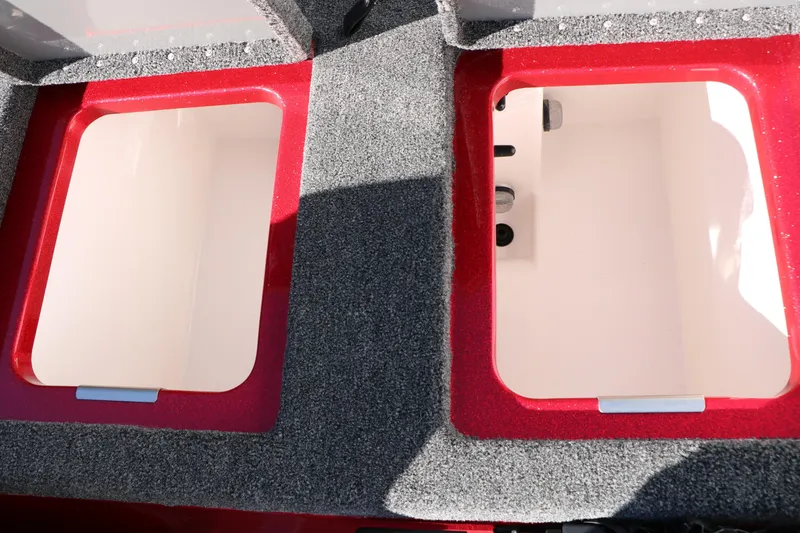 Slide: The Image of 2025 Caymas CX 20 PRO boat storage compartments with red trim and gray carpet. - 39