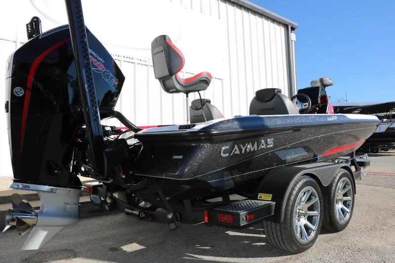 Slide: The Image of 2025 Caymas CX 20 PRO boat with dual axle trailer, parked outdoors. - 4