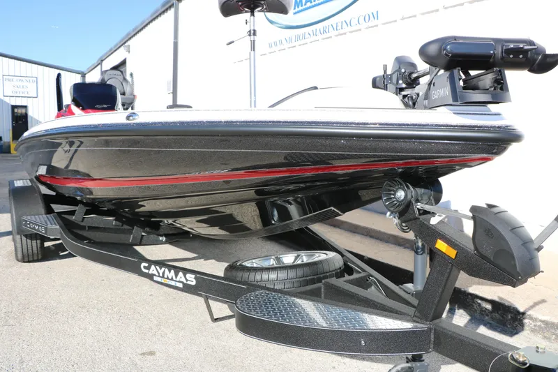 Slide: The Image of 2025 Caymas CX 20 PRO boat on trailer, featuring sleek black and red design. - 6