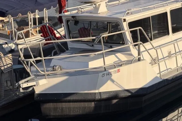 Slide: The Image of 2007 ACB Sportfisher boat deck with metal railings and dock view. - 2