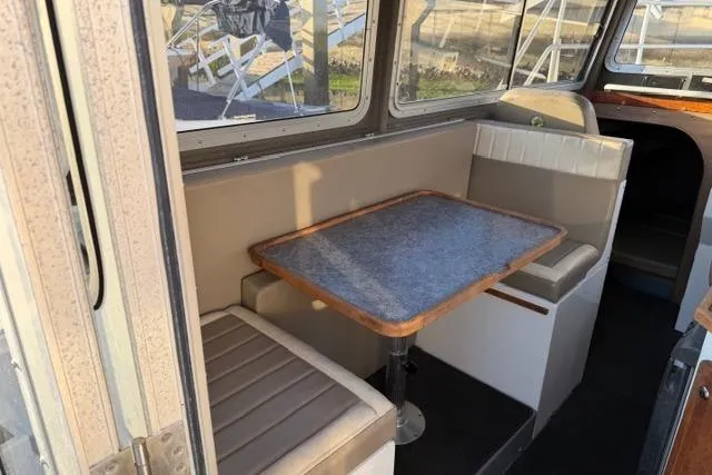 Slide: The Image of 2007 ACB Sportfisher boat interior with dining area and cushioned seating. - 20