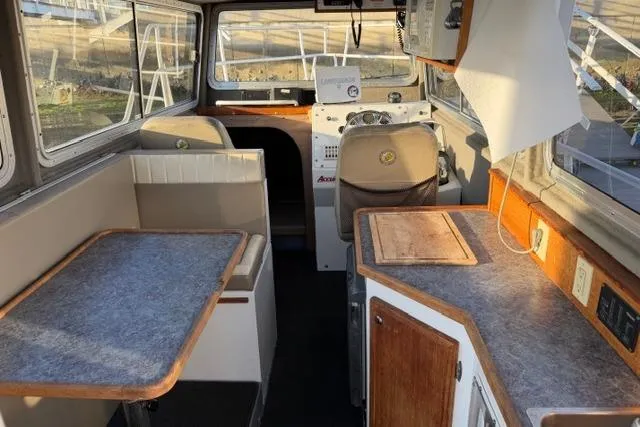 Slide: The Image of 2007 ACB Aluminum Chambered Boats Sportfisher interior with seating, table, and control panel. - 21