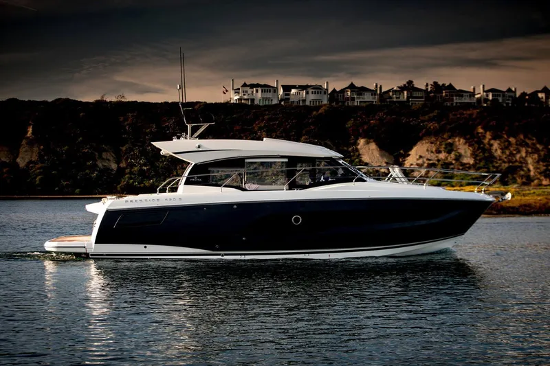 Slide: The Image of Manufacturer Provided Image: 2023 Prestige 420 S yacht cruising on calm waters at sunset. - 5