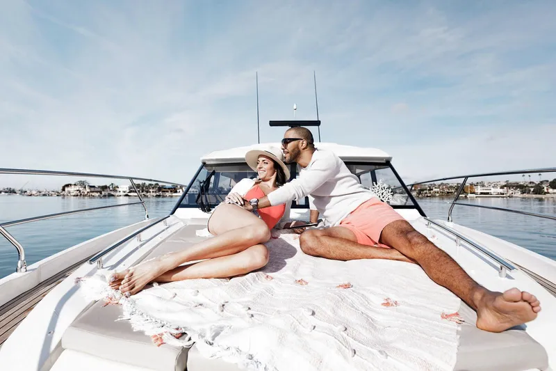 Slide: The Image of Manufacturer Provided Image: Couple relaxing on 2023 Prestige 420 S yacht deck, enjoying a sunny day. - 7
