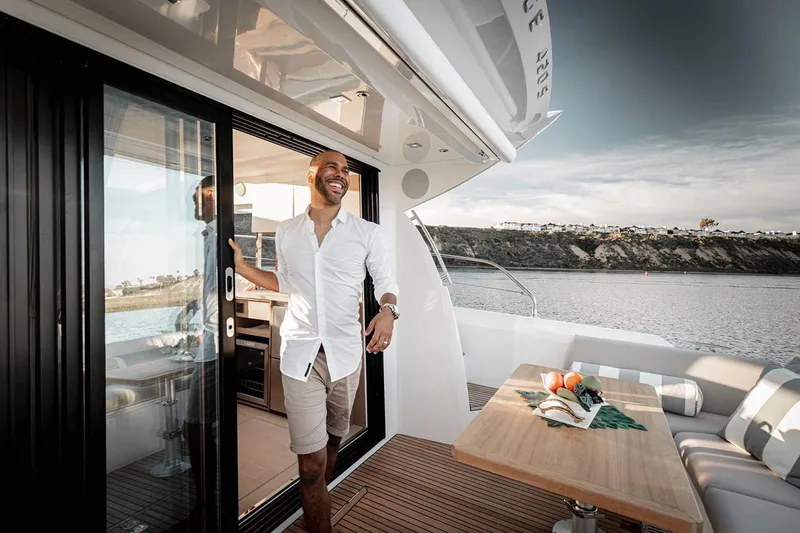 Slide: The Image of Manufacturer Provided Image: Man enjoying the deck of a 2023 Prestige 420 S yacht. - 8