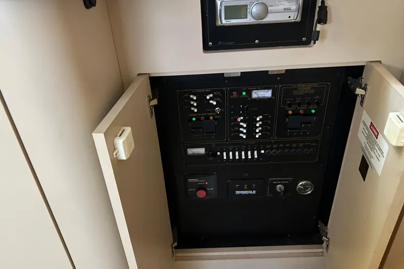 Slide: The Image of Control panel inside a 2000 Cruisers Yachts 3750 Motoryacht, featuring various switches and gauges. - 11
