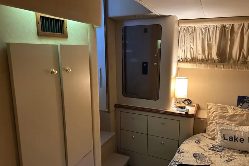 Slide: The Image of 2000 Cruisers Yachts 3750 Motoryacht interior with cozy bedroom and soft lighting. - 12