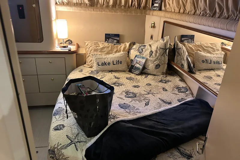 Slide: The Image of Cozy bedroom in 2000 Cruisers Yachts 3750 Motoryacht with nautical decor and soft lighting. - 13