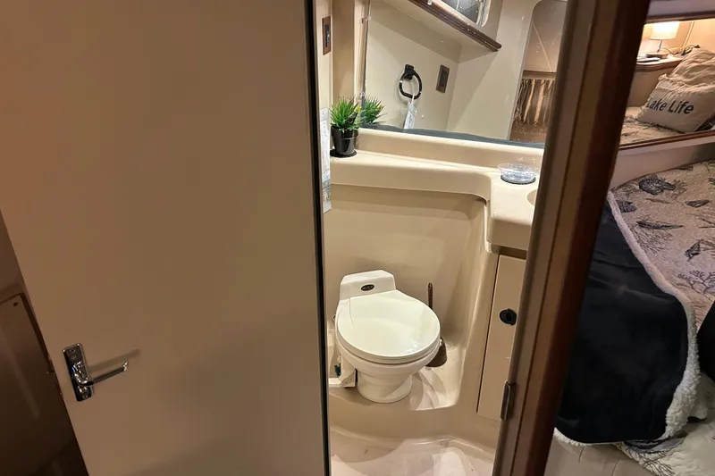 Slide: The Image of 2000 Cruisers Yachts 3750 Motoryacht bathroom with toilet and sink, cozy interior design. - 16