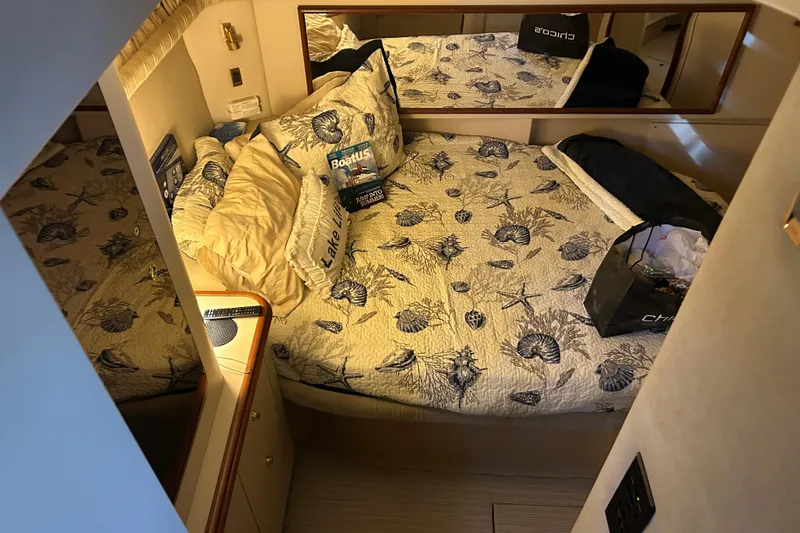 Slide: The Image of Cozy bedroom in 2000 Cruisers Yachts 3750 Motoryacht with nautical-themed bedding. - 19