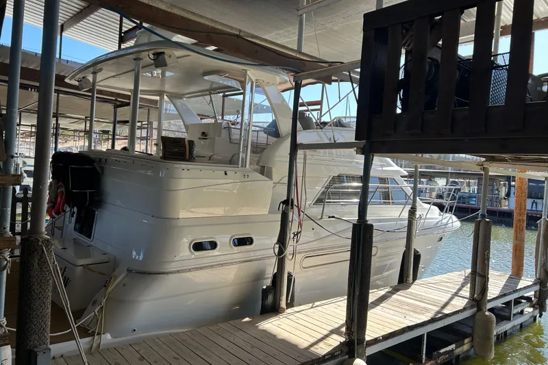 Slide: The Image of 2000 Cruisers Yachts 3750 Motoryacht docked in a marina under shelter. - 2