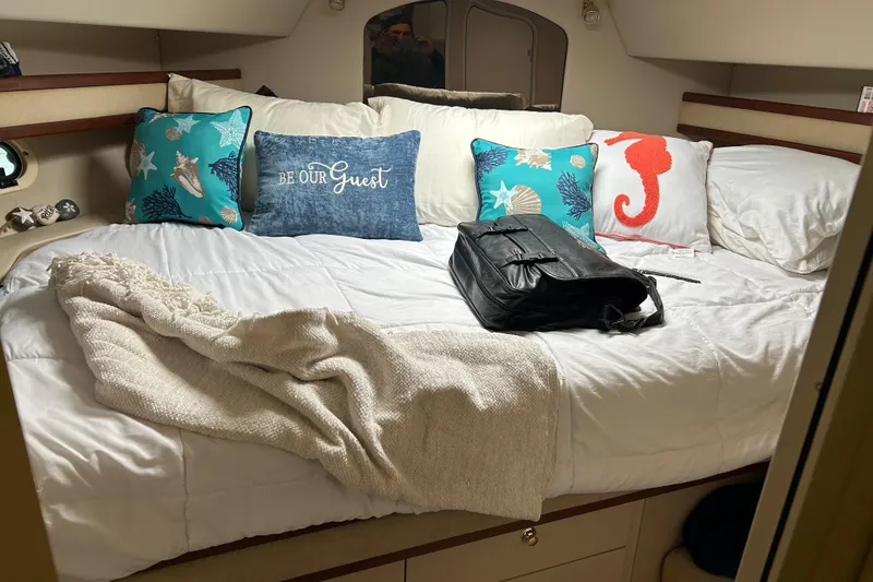 Slide: The Image of Cozy bedroom in 2000 Cruisers Yachts 3750 Motoryacht with decorative pillows and blanket. - 22