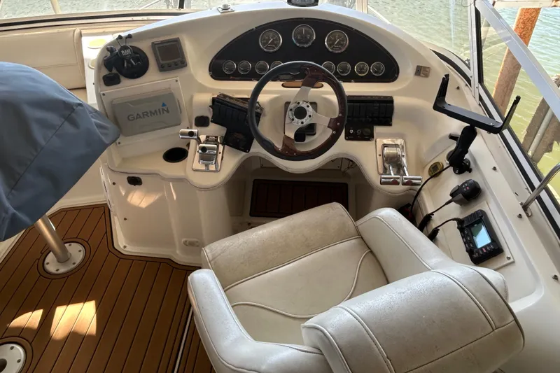 Slide: The Image of 2000 Cruisers Yachts 3750 Motoryacht helm with Garmin navigation and wood-accented steering wheel. - 27