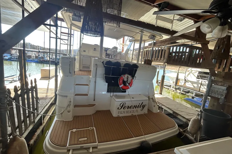 Slide: The Image of 2000 Cruisers Yachts 3750 Motoryacht docked, named "Serenity," in a marina setting. - 3