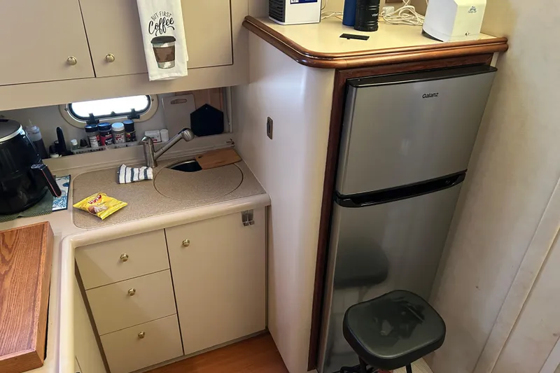 Slide: The Image of Compact kitchen area in a 2000 Cruisers Yachts 3750 Motoryacht with sink and fridge. - 8