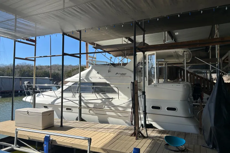 The Image of 2000 Cruisers Yachts 3750 Motoryacht docked under covered marina. - 0