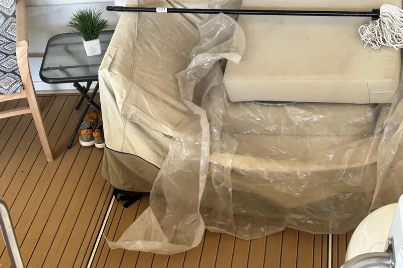 Slide: The Image of Interior of 2000 Cruisers Yachts 3750 Motoryacht with covered seating and wooden flooring. - 23