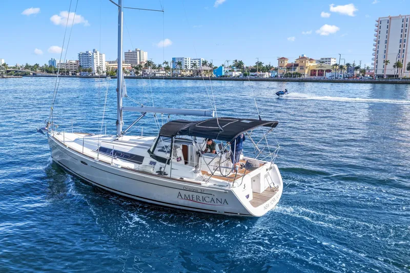Slide: The Image of 2014 Beneteau Oceanis 37 sailboat cruising near a city waterfront. - 12