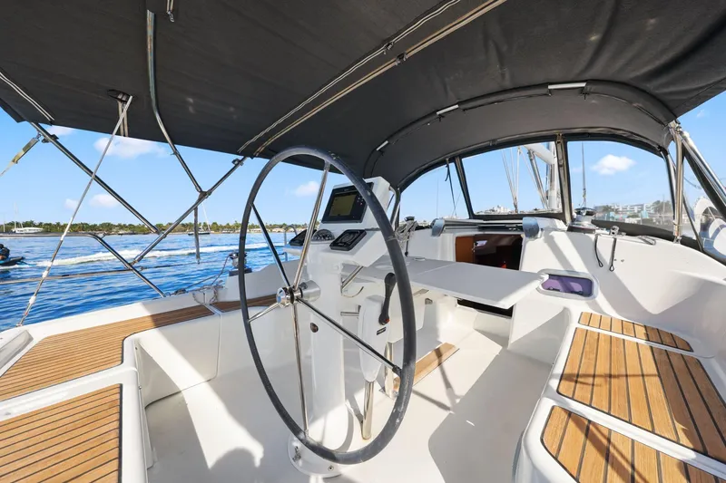 Slide: The Image of Cockpit of 2014 Beneteau Oceanis 37 sailboat with steering wheel and wooden seating. - 18