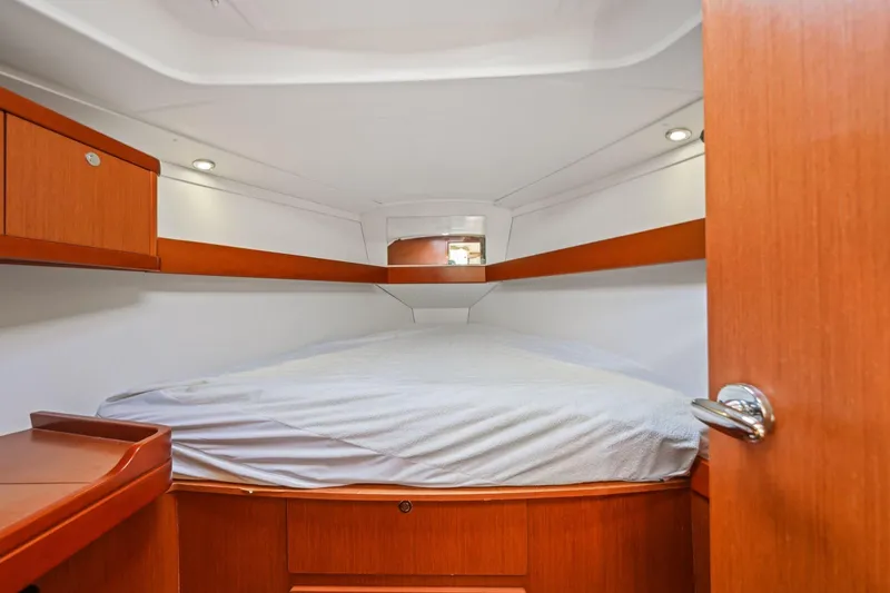 Slide: The Image of 2014 Beneteau Oceanis 37 cabin interior with wooden finish and cozy bed. - 23