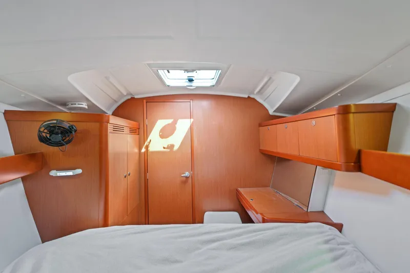Slide: The Image of Interior cabin of 2014 Beneteau Oceanis 37 sailboat, featuring wood finish and compact design. - 24