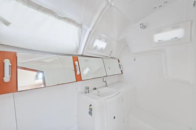 Slide: The Image of Bathroom interior of 2014 Beneteau Oceanis 37 yacht, featuring sink and mirrors. - 25