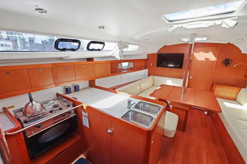 Slide: The Image of Interior of 2014 Beneteau Oceanis 37 yacht with modern kitchen and seating area. - 28