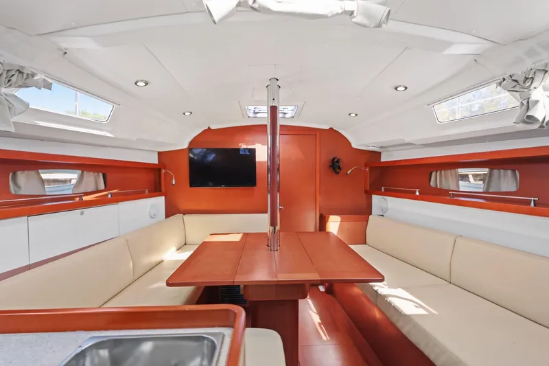 Slide: The Image of Interior of 2014 Beneteau Oceanis 37 sailboat with modern seating and wooden finishes. - 32