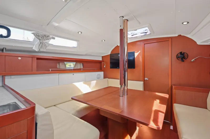 Slide: The Image of Interior of 2014 Beneteau Oceanis 37 sailboat with modern seating and wooden finishes. - 33
