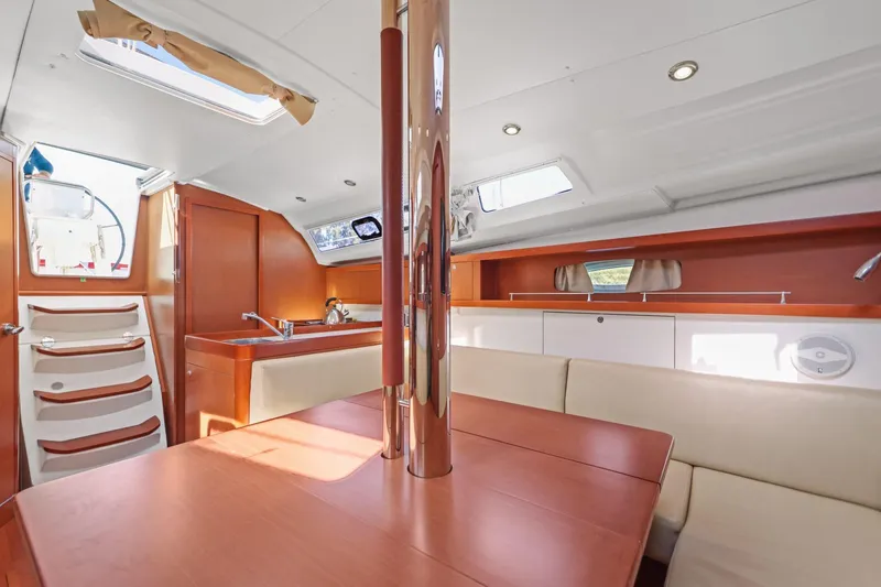 Slide: The Image of Interior of 2014 Beneteau Oceanis 37 sailboat with modern wood finish and seating area. - 34