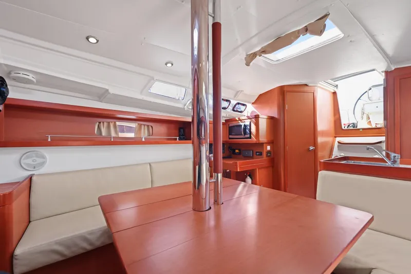 Slide: The Image of Interior of 2014 Beneteau Oceanis 37 sailboat with modern wood finish and seating area. - 35