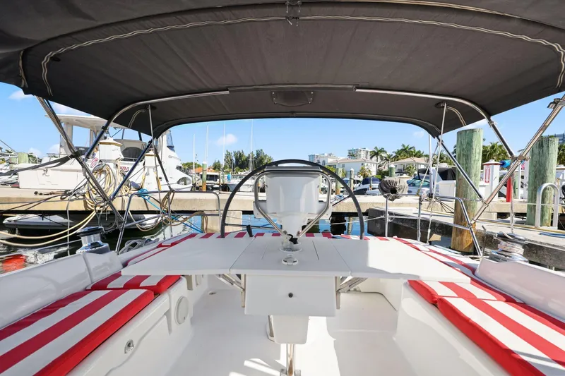 Slide: The Image of 2014 Beneteau Oceanis 37 sailboat cockpit with striped cushions, docked at marina. - 37