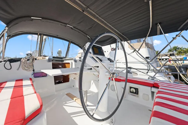 Slide: The Image of Cockpit of 2014 Beneteau Oceanis 37 sailboat with striped seating and steering wheel. - 39