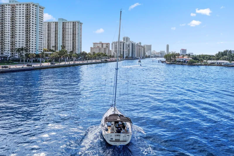 Slide: The Image of Beneteau Oceanis 37 sailing in a city canal, surrounded by tall buildings, 2014 model. - 4